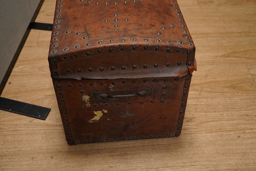 A 19th century leather and brass studded domed trunk, 65cm wide x 36cm high